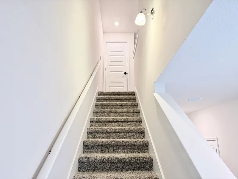 Upstairs hallway connecting the three bedrooms and two full bathrooms