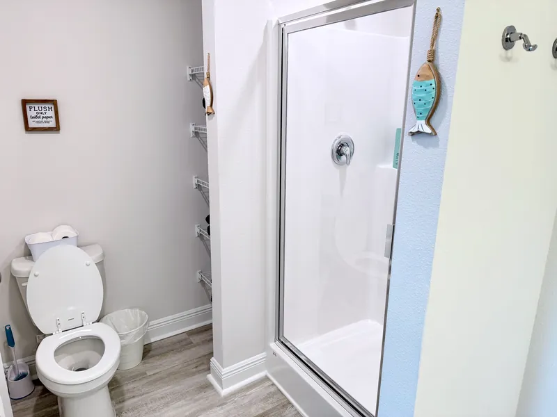 Primary bathroom vanity with mirror and storage