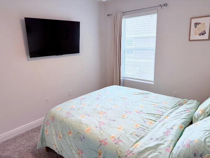 Queen guest bedroom with nightstand and lamp