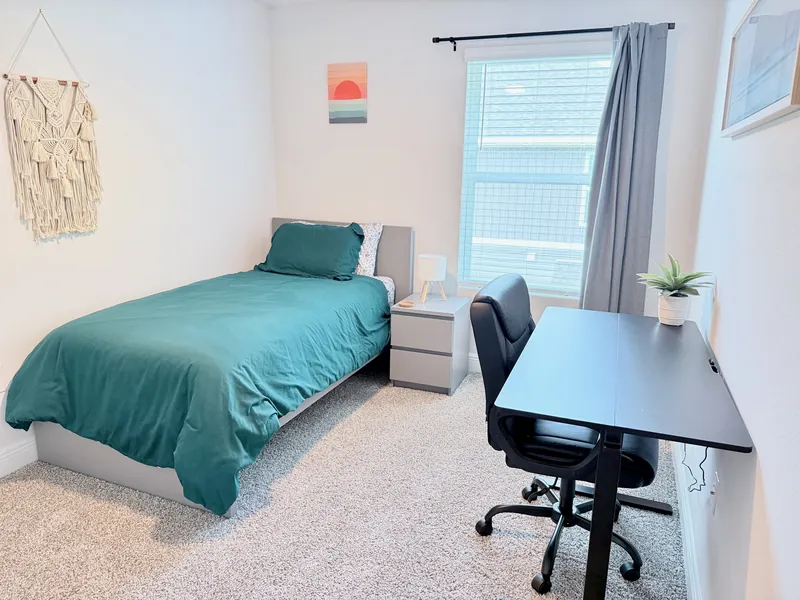 Third bedroom with twin bed and standing desk workspace for remote work or IWTC study