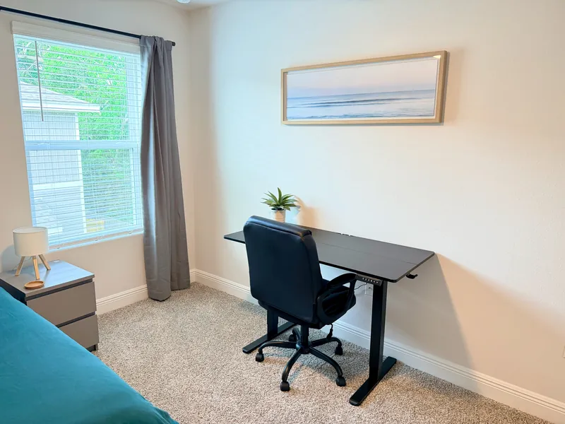 Twin bedroom with study area and natural light